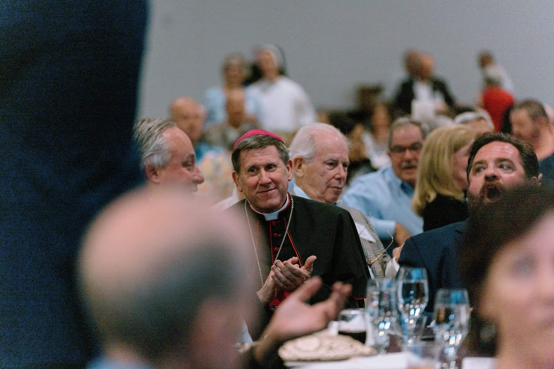 Bishop Spalding clapping at a diocesan event