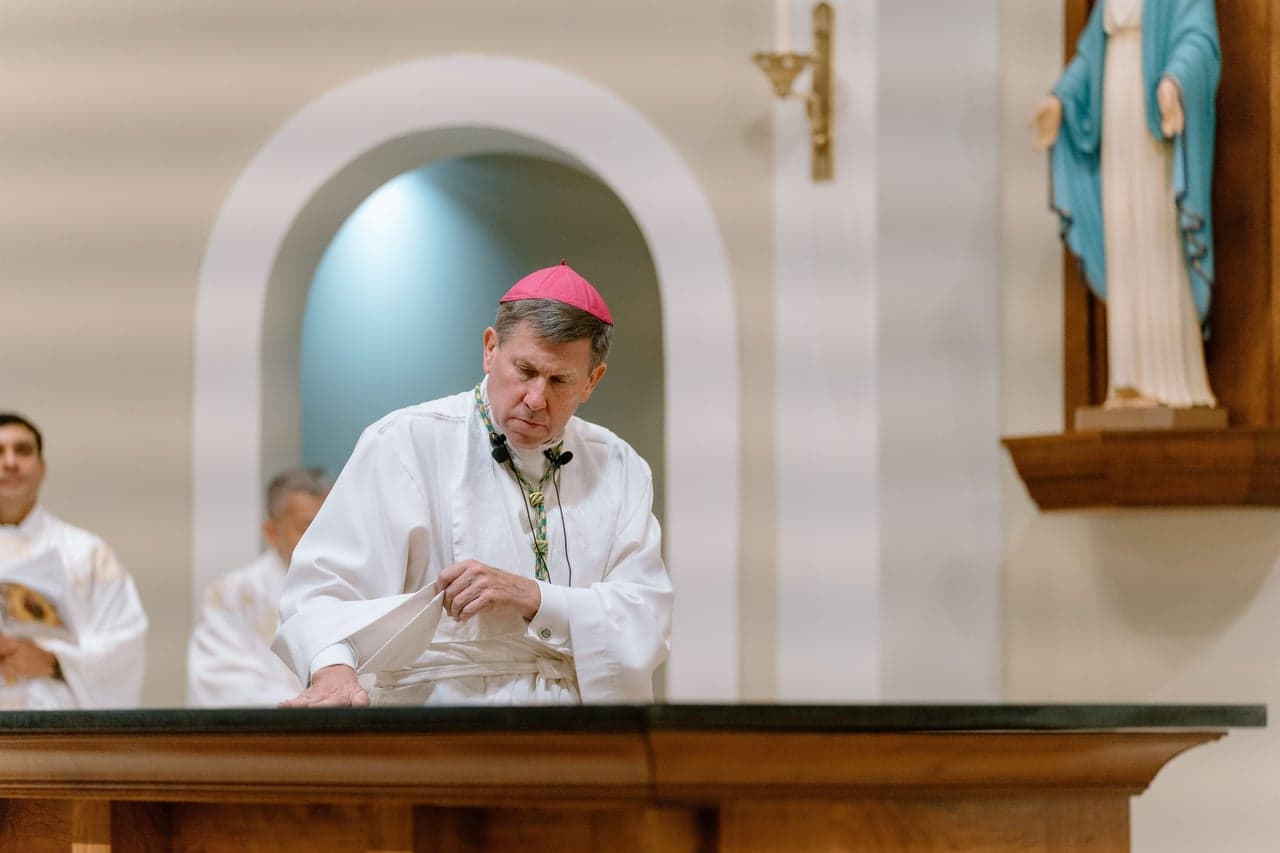 Bishop Spalding laying hands